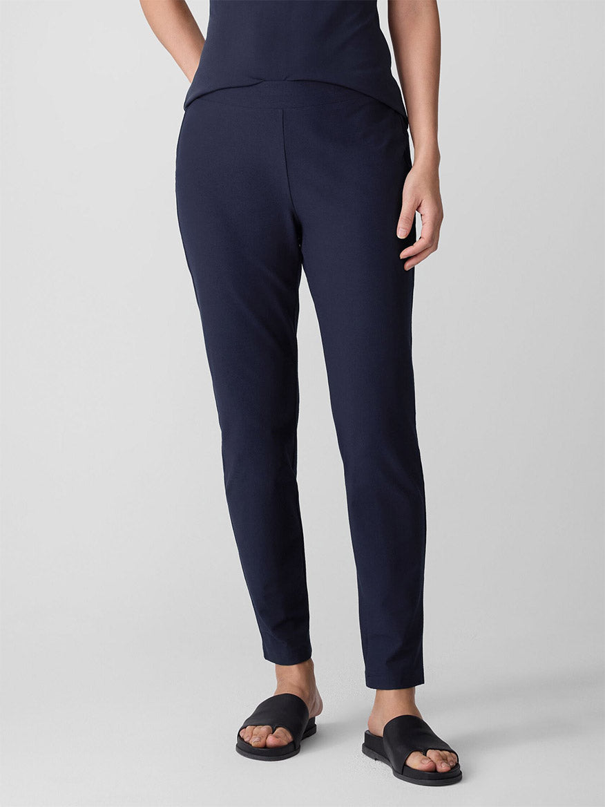 Dark navy slim-fit ankle pants on model, front view with matching top