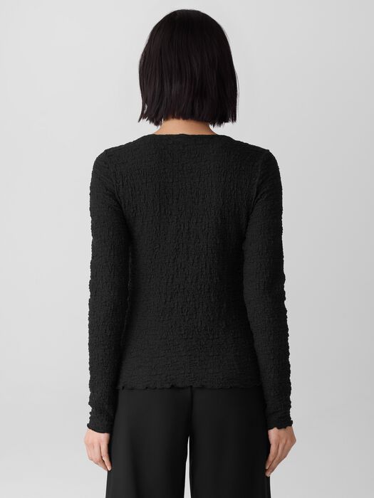 Back view of textured bubble jacquard long-sleeve top with round neck on model
