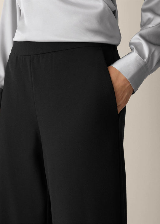 front view of plus size Eileen Fisher Washable Flex Ponte Wide Leg Ankle Pant in Black