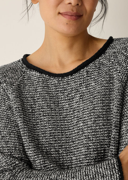 close up front view of plus size Eileen Fisher  Peruvian Cotton Cloud Jewel Neck Sweater in Black Soft White