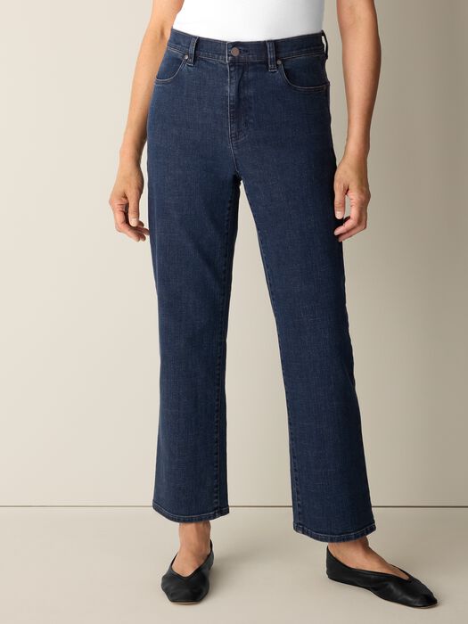 Dark indigo straight-leg ankle jeans with five-pocket styling, worn with black ballet flats
