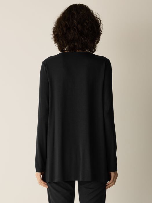 Long-sleeve black A-line tunic top shown from the back on a model