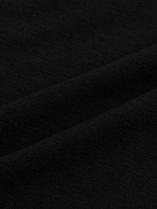 Close-up detail of fine stretch jersey knit fabric in deep black with subtle texture