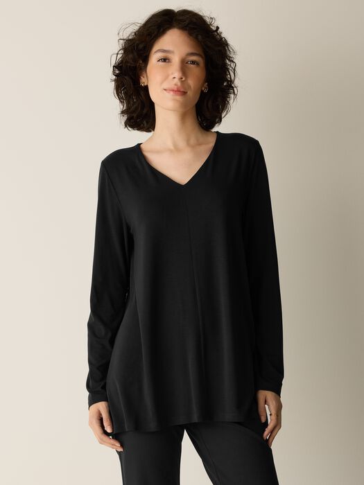 Long-sleeve black V-neck A-line tunic top with relaxed fit, front view on model