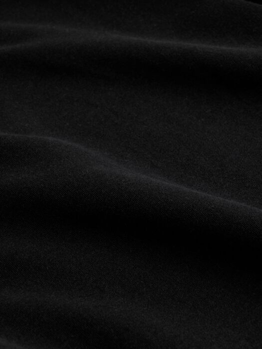 Close-up detail of soft brushed terry fabric texture in deep black