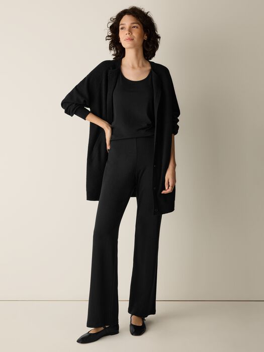 Full-length black kick flare pants with matching tank and long cardigan, front view on model