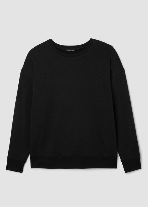 Black long-sleeve crew neck sweatshirt laid flat, featuring ribbed cuffs and hem