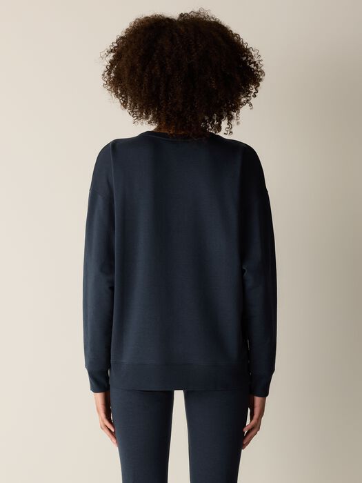 Dark navy crew neck sweatshirt shown from the back on a model, long relaxed fit