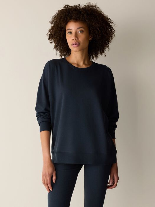 Dark navy crewneck sweatshirt with long sleeves and relaxed fit, front view on model