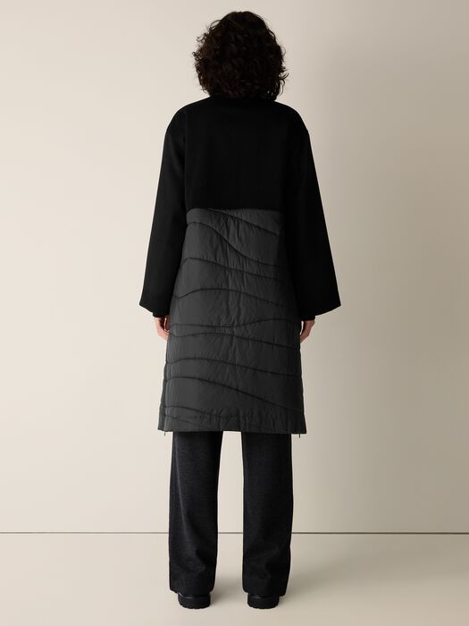 Black stand-collar coat with gray quilted back panel and buttoned placket.