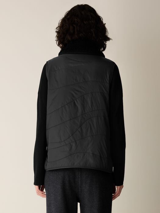 Black vest back view with diagonal quilting and relaxed fit, stand collar