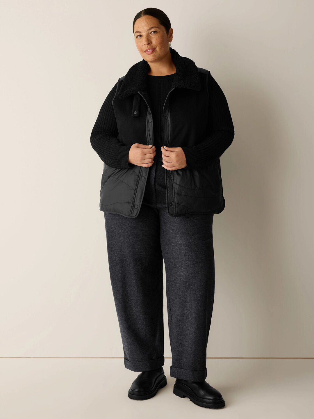 Black classic-collar sleeveless vest with button front and flap pockets