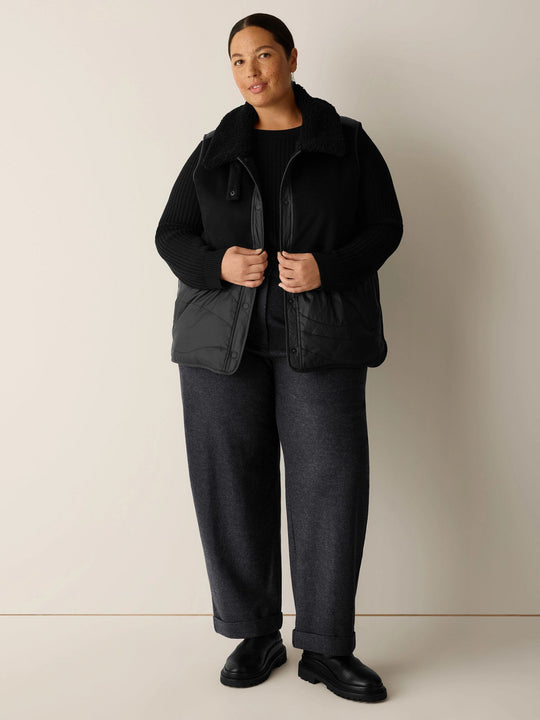 Black classic-collar sleeveless vest with button front and flap pockets