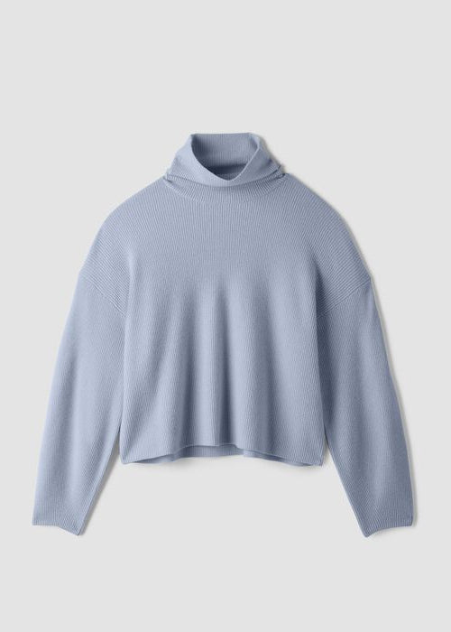 Light blue ribbed knit turtleneck sweater with wide sleeves, flat lay view