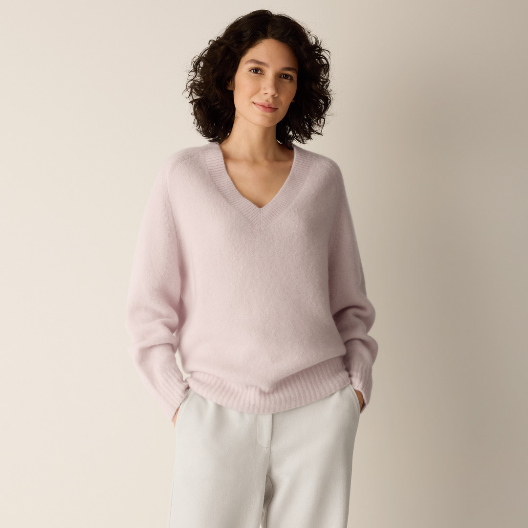 Light mauve V-neck sweater with ribbed cuffs, hem, and relaxed fit.