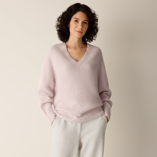 Light mauve V-neck sweater with ribbed cuffs, hem, and relaxed fit.