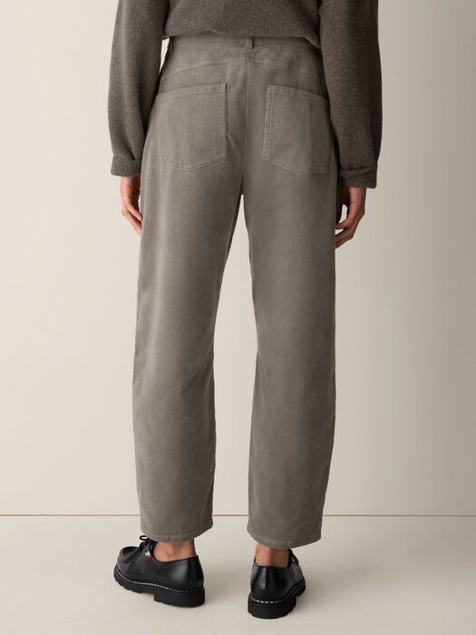 Rear view of relaxed ankle pants with two back patch pockets, worn with black loafers