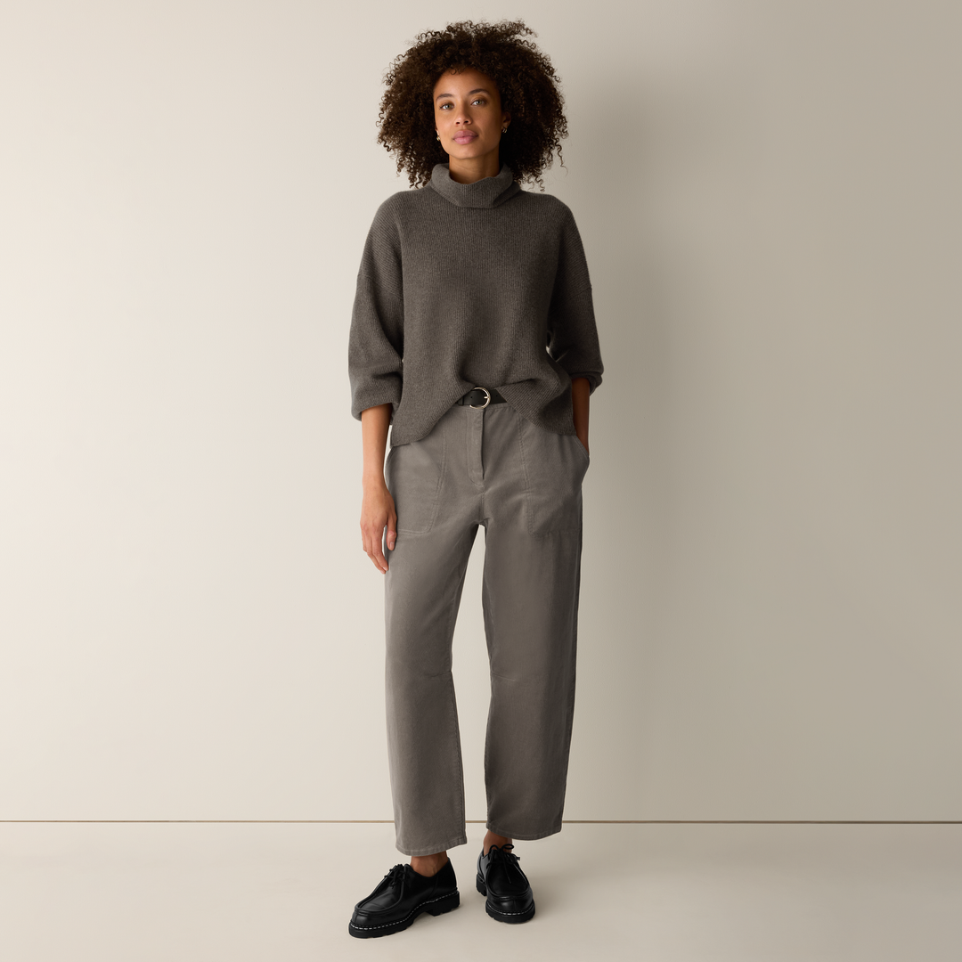Wide-leg cropped corduroy ankle pants with front pockets and belt, worn by model with turtleneck sweater