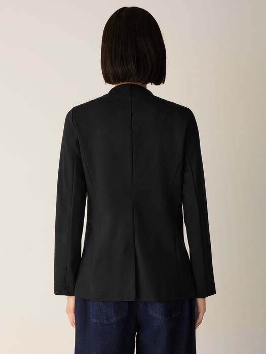 Black structured blazer rear view on model, showing seam detail and fitted silhouette