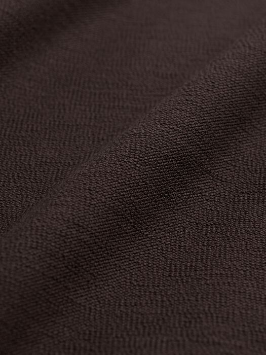 Close-up of dark brown stretch crepe fabric showing texture and subtle drape