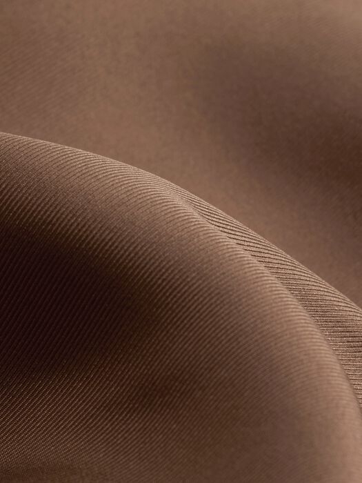 Silk twill fabric close-up with fine woven texture, hazel brown