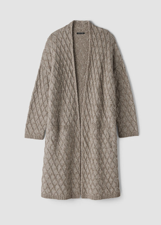 A long open-front cable-knit cardigan in a warm taupe-beige color, displayed against a solid light gray background.