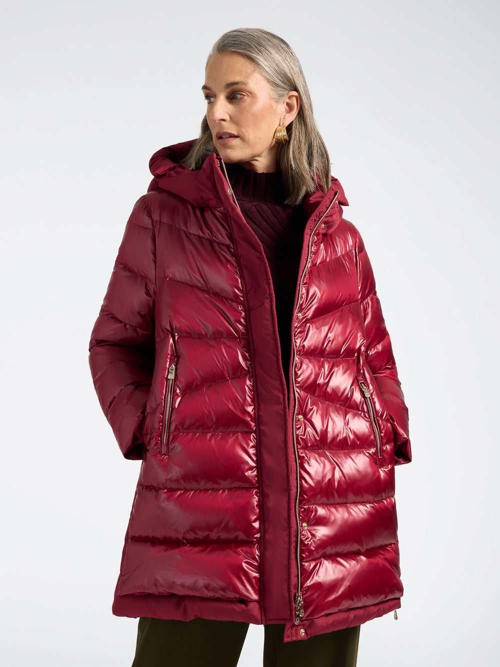 Deep red hooded puffer jacket with front zipper and quilted baffle panels
