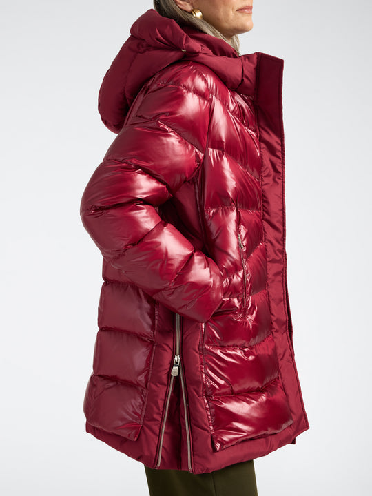 Deep red hooded puffer jacket with high collar, shiny finish, and long zipper