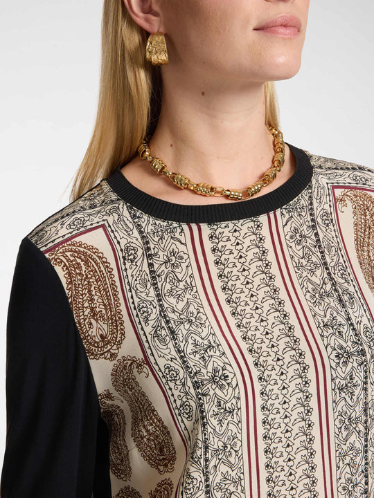 Long sleeve round-neck jersey top close-up of ornate front print with black trim