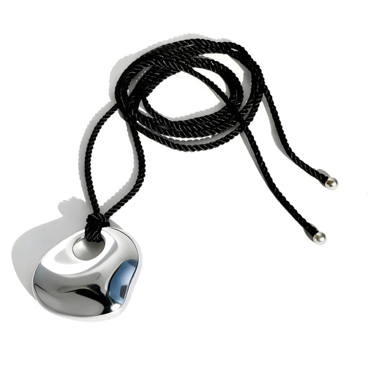 Silver pendant with curved organic shape on black braided cord necklace