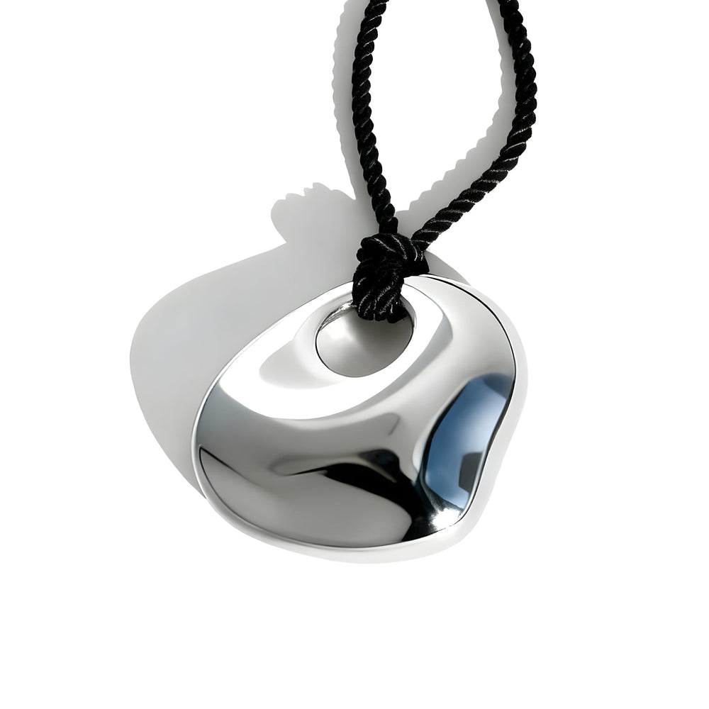 Modern silver metallic pendant with curved geometric design on black twisted cord necklace