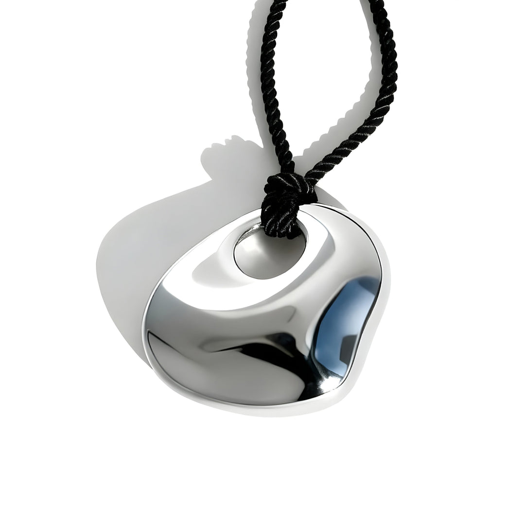 Modern silver metallic pendant with curved geometric design on black twisted cord necklace