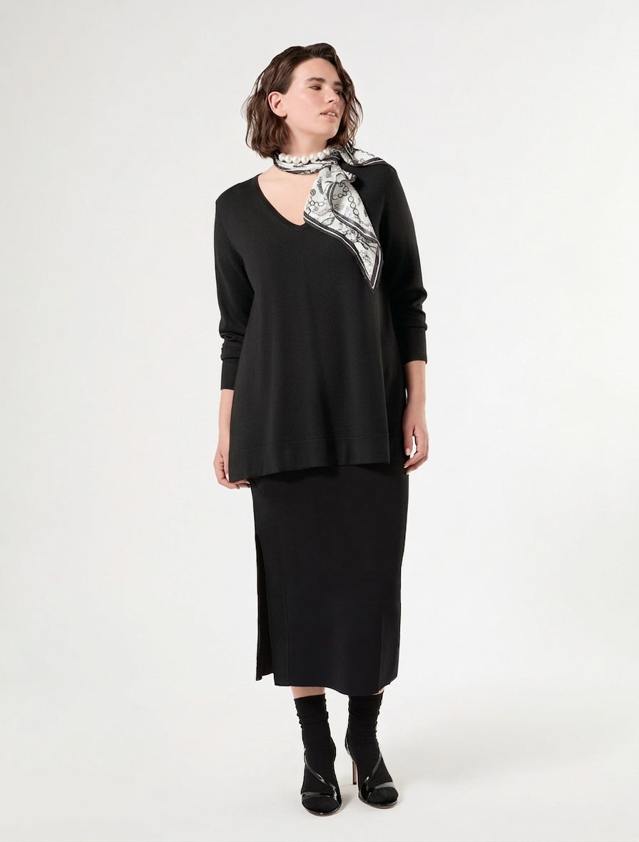 Black V-neck long-sleeve sweater on model, draped fit