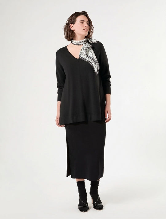 Black V-neck long-sleeve sweater on model, draped fit