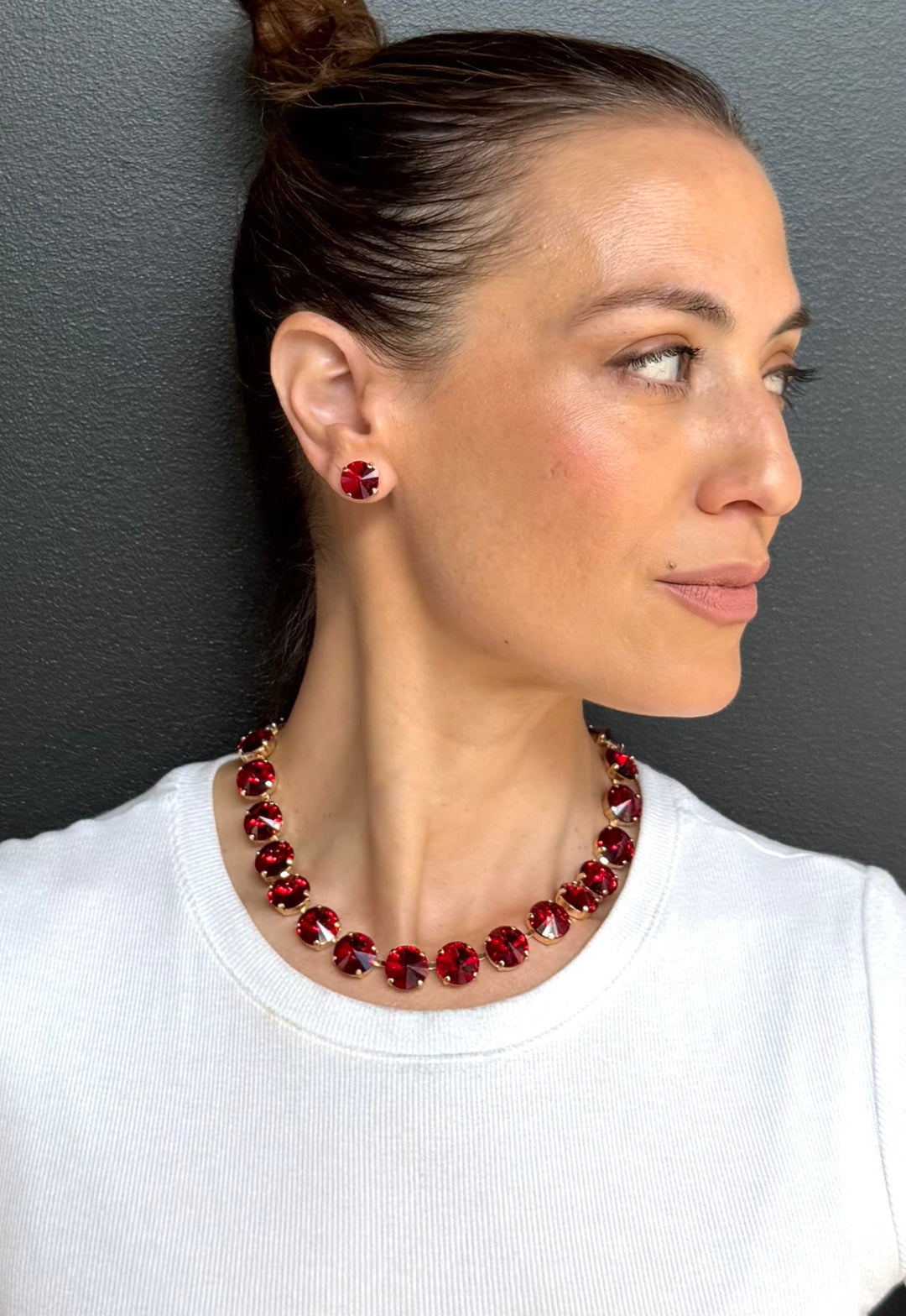 Ruby red faceted rivoli necklace on model with gold-tone chain and clasp