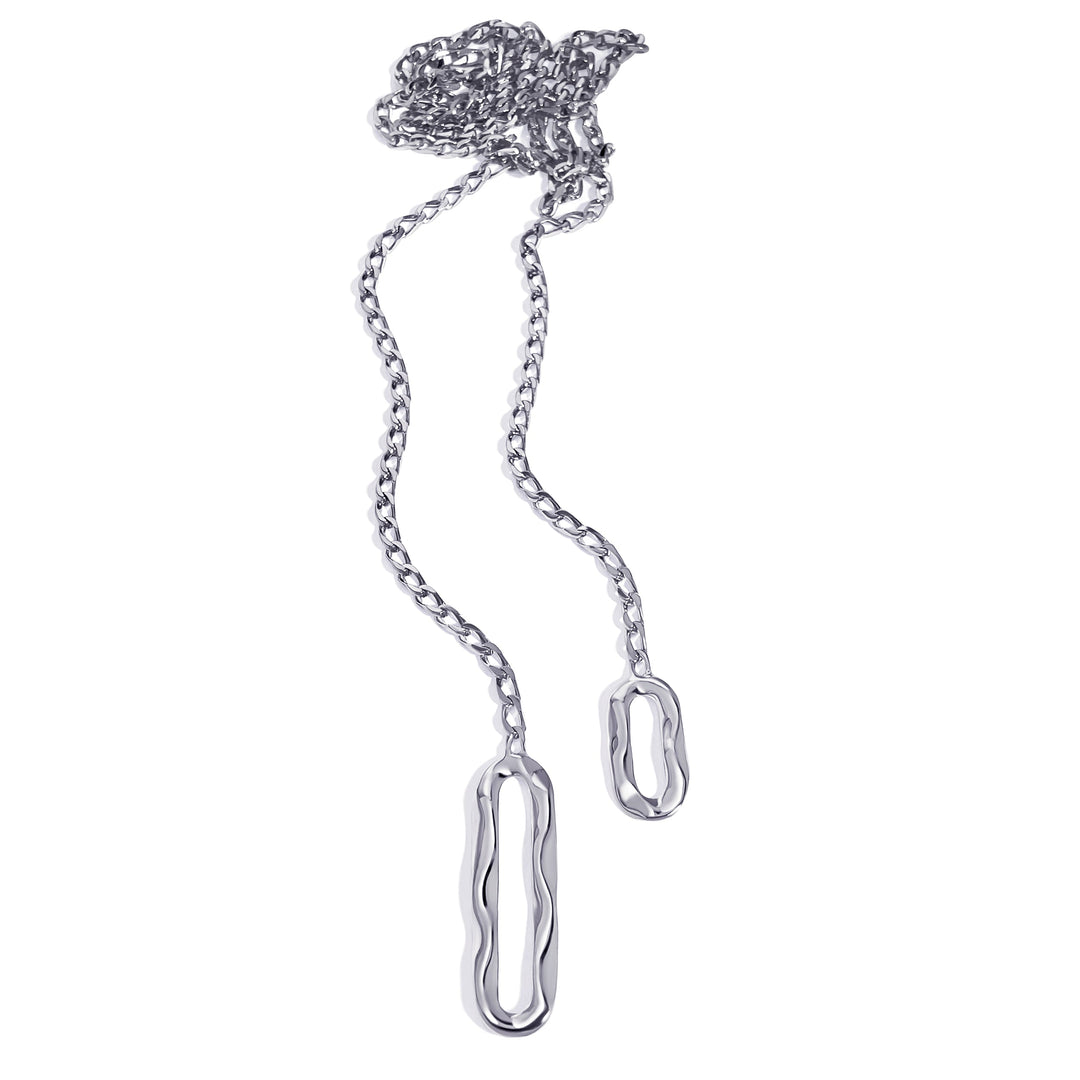 Lariat necklace with chain links and oval pendant attachments on white background