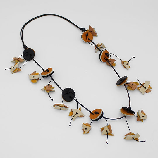 Statement necklace with circular discs and leaf-shaped charms on black cord