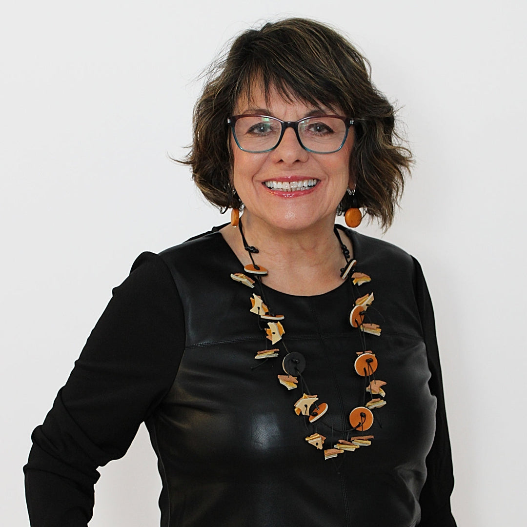 Statement necklace with geometric yellow and brown circular elements worn by model