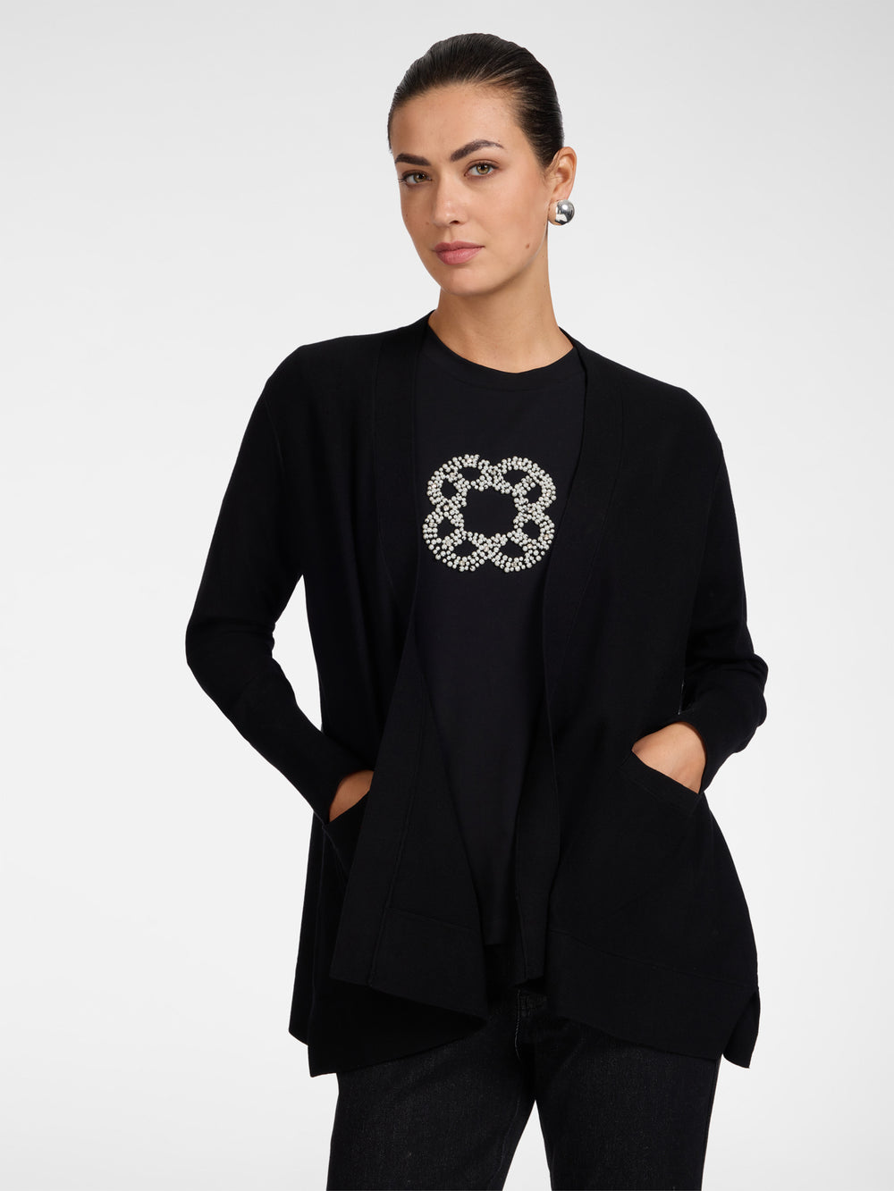 Black flared cardigan with open front, embellished flower applique, side pockets
