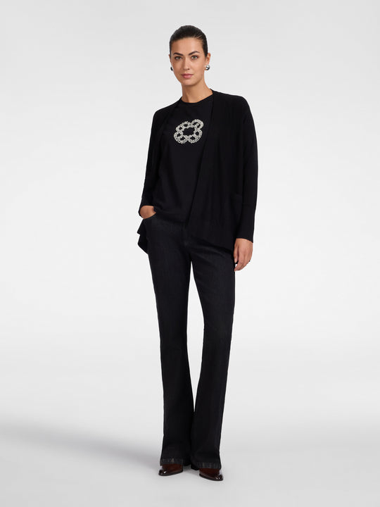Black flared cardigan with open front, side pockets, and long sleeves