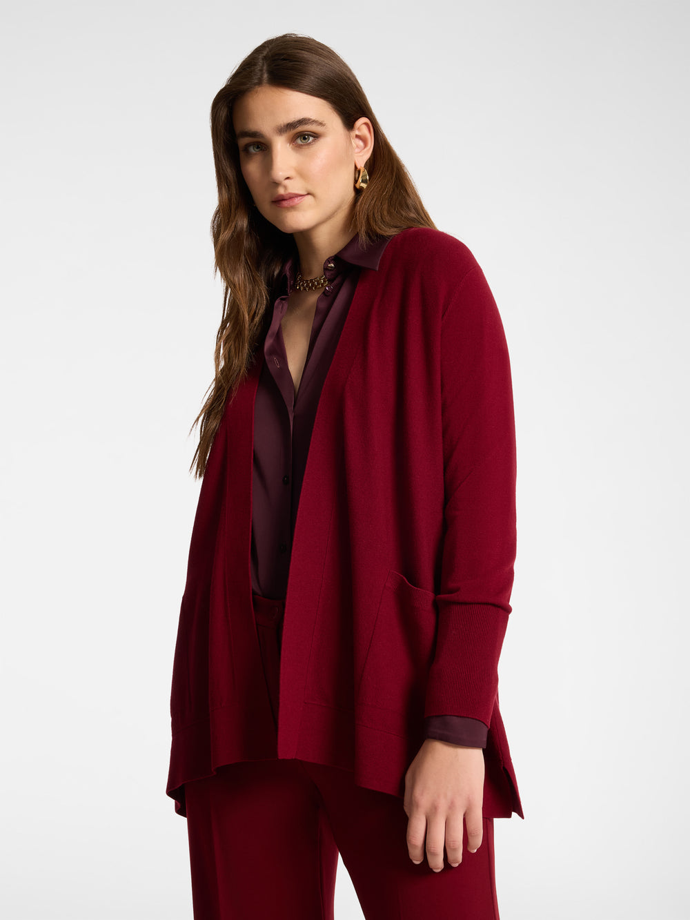 Red flared cardigan with pockets, long sleeves, and open front