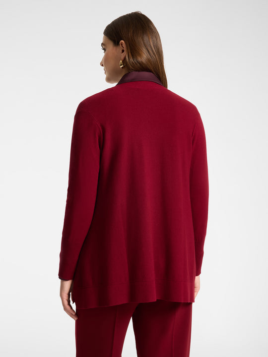 Back view of red flared cardigan with long sleeves and open front