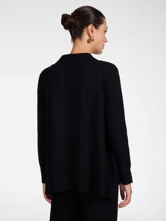 Black polo knit tunic from back view, long sleeves, curved hem