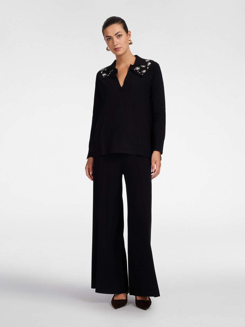 Black polo knit tunic with flared silhouette and three-quarter sleeves