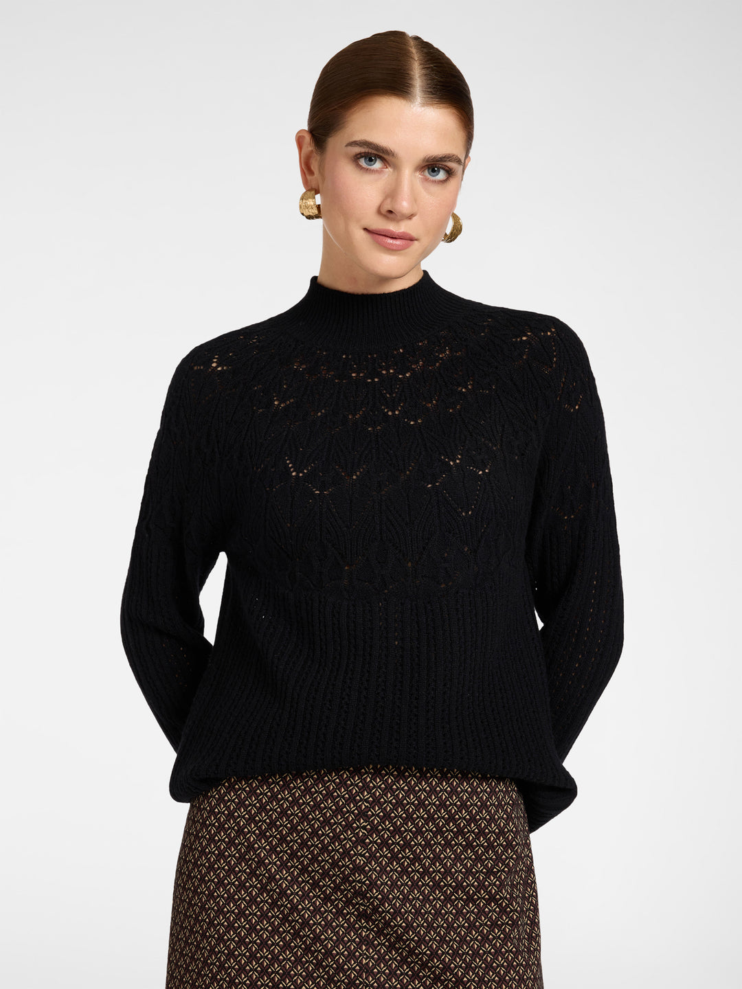 Black wool rib knit pullover with perforated pattern, mock neck, long sleeves