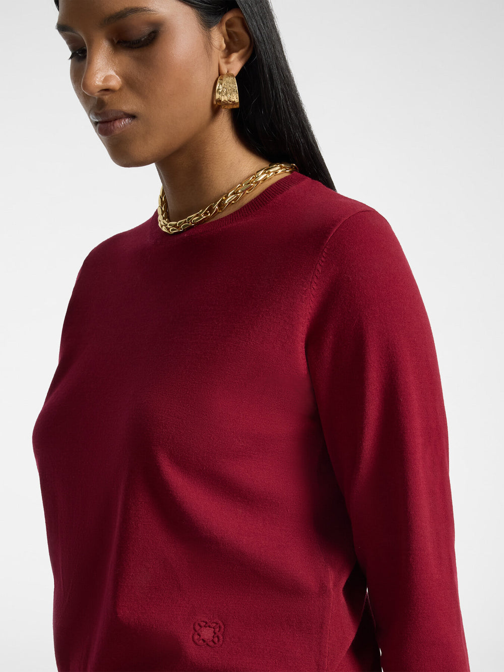 Burgundy long-sleeve pullover with crew neck and subtle embroidered logo