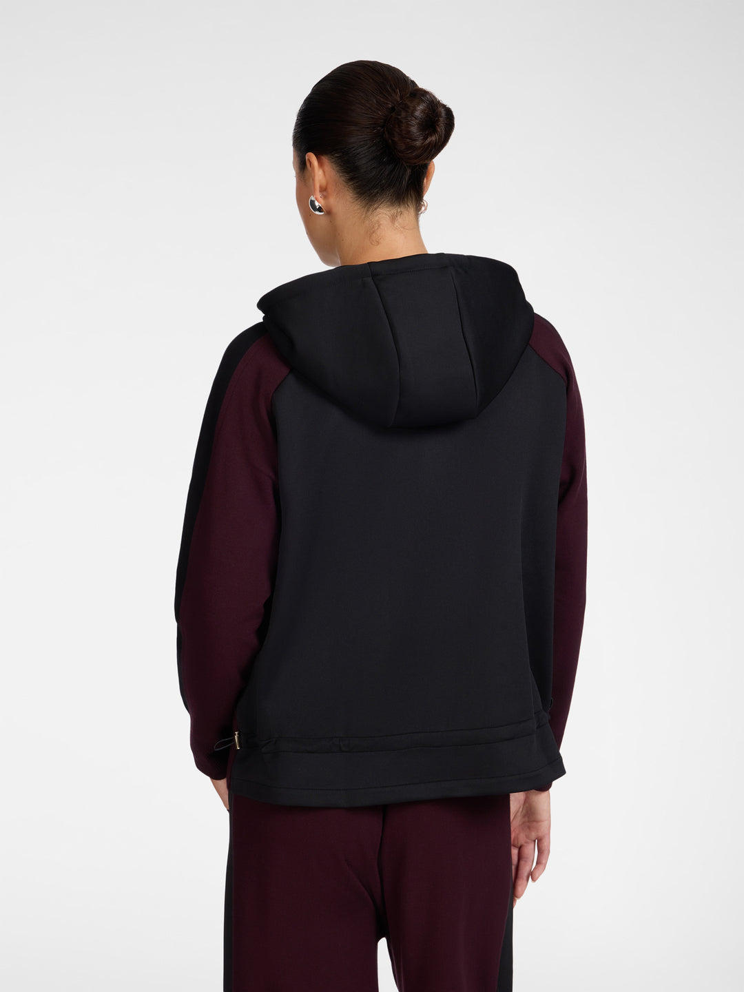 Back view hooded zip cardigan with black hood paneling and dark maroon sleeves