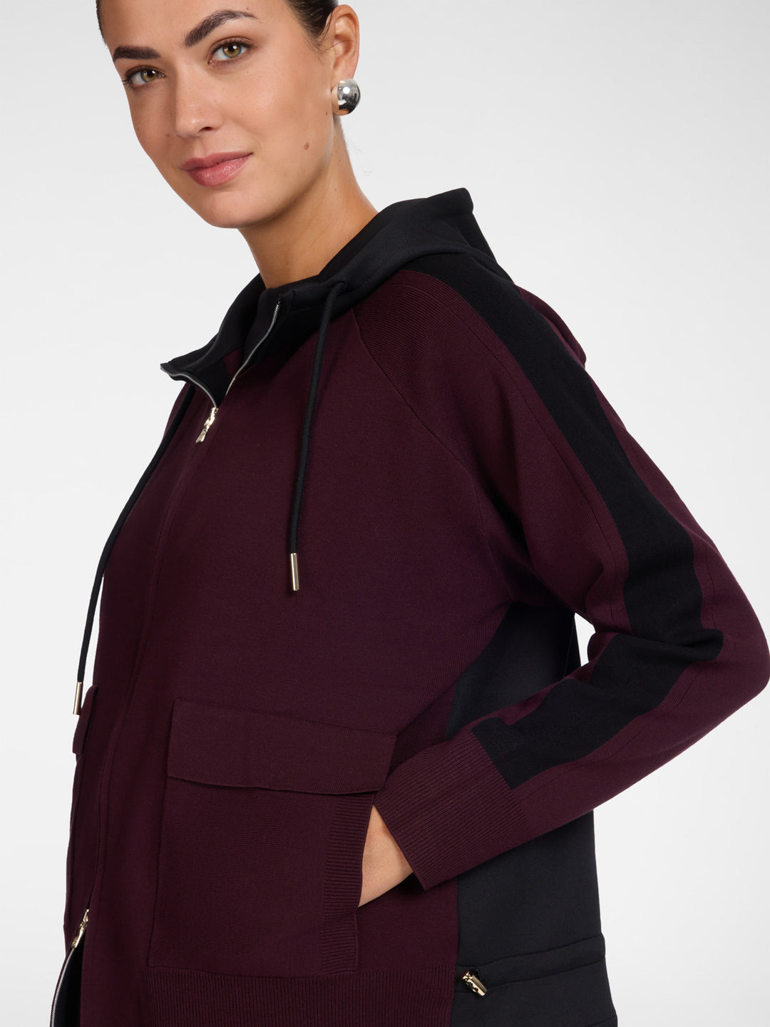Side view hooded zip cardigan in dark maroon with drawstring hood and patch pockets