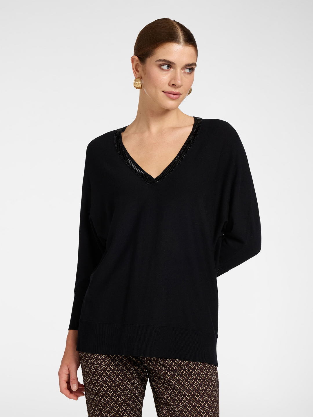 Black V-neck tunic with embroidered neckline trim and relaxed kimono sleeves