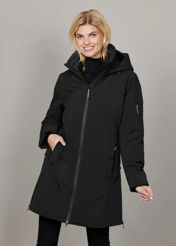 Woman wearing a black coat against a gray background